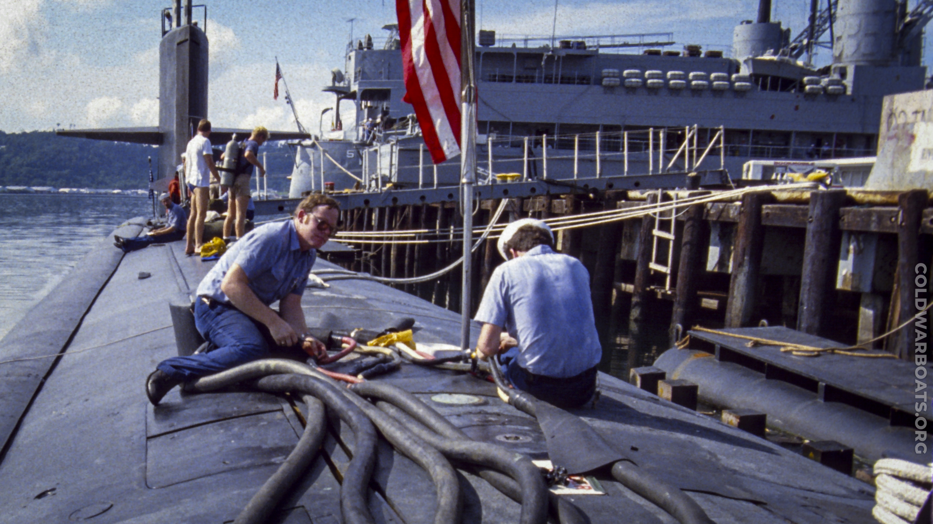 E Division unrigs shore power while divers prepare for a pre-underway hull inspection on the USS WILLIAM H. BATES (SSN 680), Subic Bay, PI - 1984